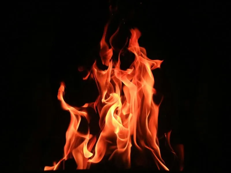 Red flames flicker against a black backdrop.