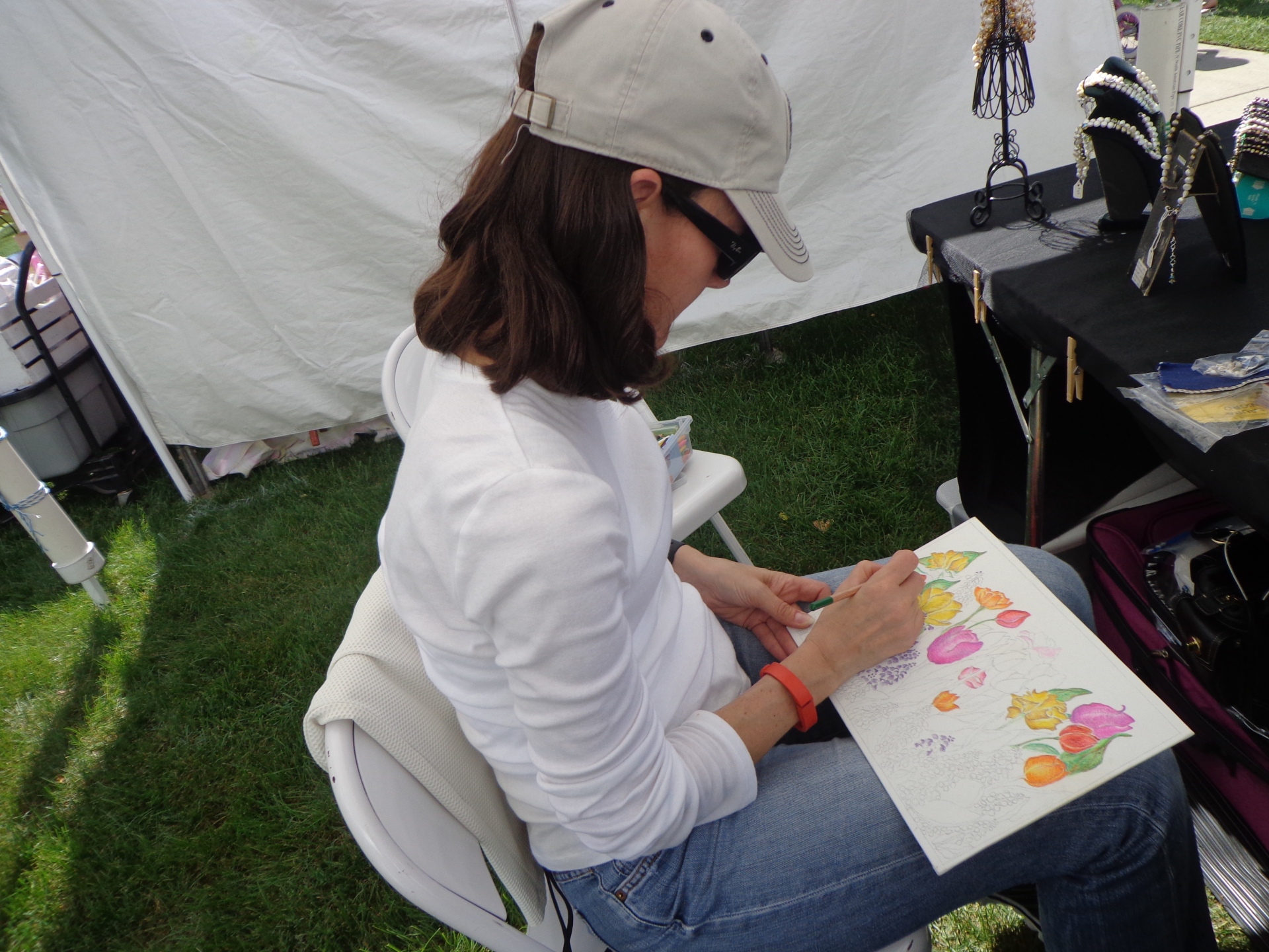 Jewelry Artist at work at her booth at show