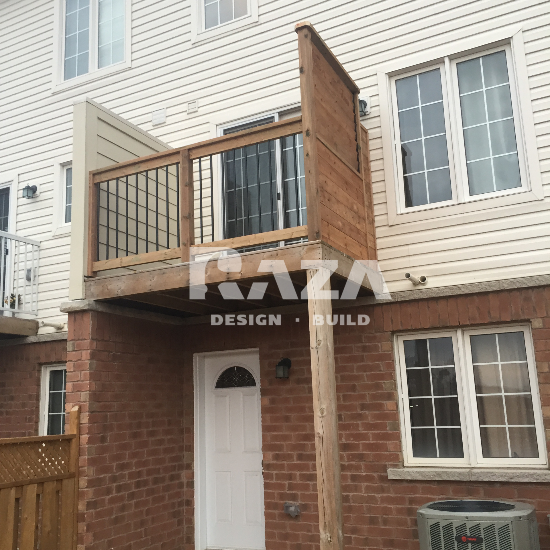 Second floor deck with black balusters and privacy screen with shutters