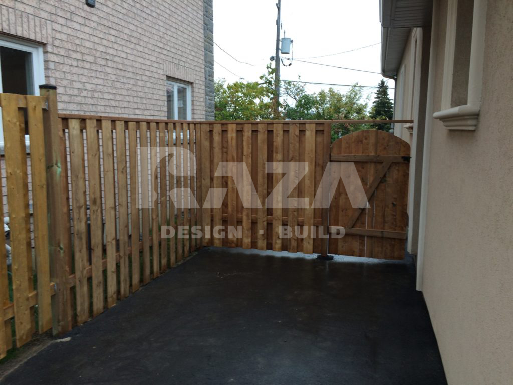 Brown pressure treated shadow box fence