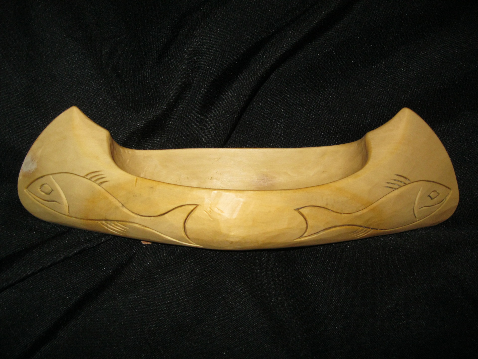 Yellow cedar canoe with carved fish