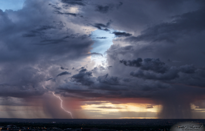 Two monsoon thunderstorms develop over Albuquerque, New Mexico at sunset, one with a cloud-to-ground lightning strike caught on camera.