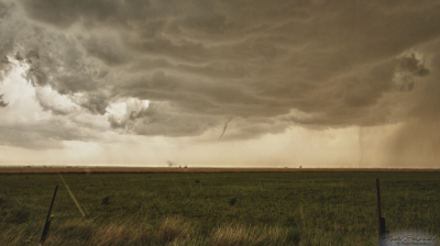A weak tornado takes shape over west central Oklahoma. Note the dust whirl displaced to the left of the funnel.