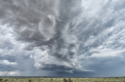 A supercell exhibits well-defined structure with a wall cloud in east central New Mexico near Pastura.