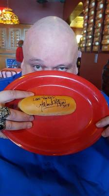 Signing Tony Packo's Hot dog Bun. 