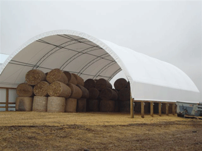Fabric covered metal frame agricultural storage hoop building