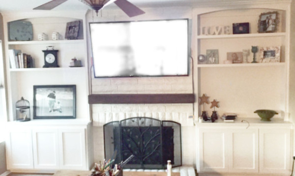 built-in shelves and cabinet with wood beam mantel