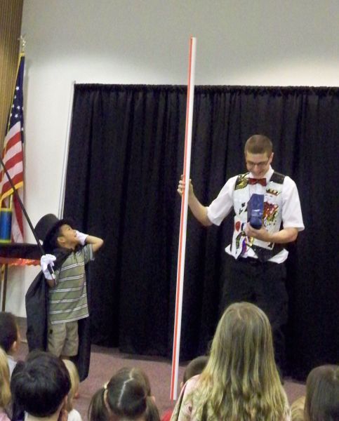 Dressing up a volunteer during the magic show