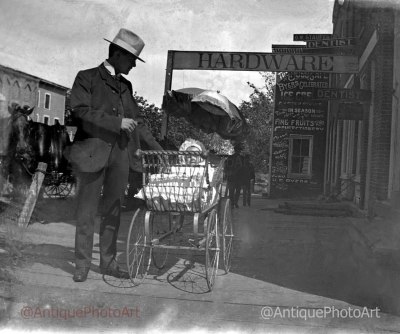 Baby Carriage in front of Hardware Store