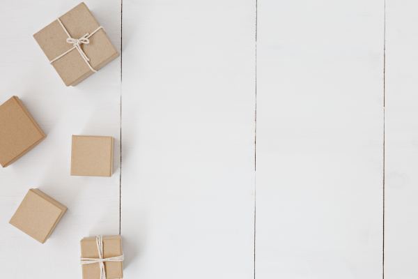 Birds eye view of 5 brown parcels on a white wooden floor