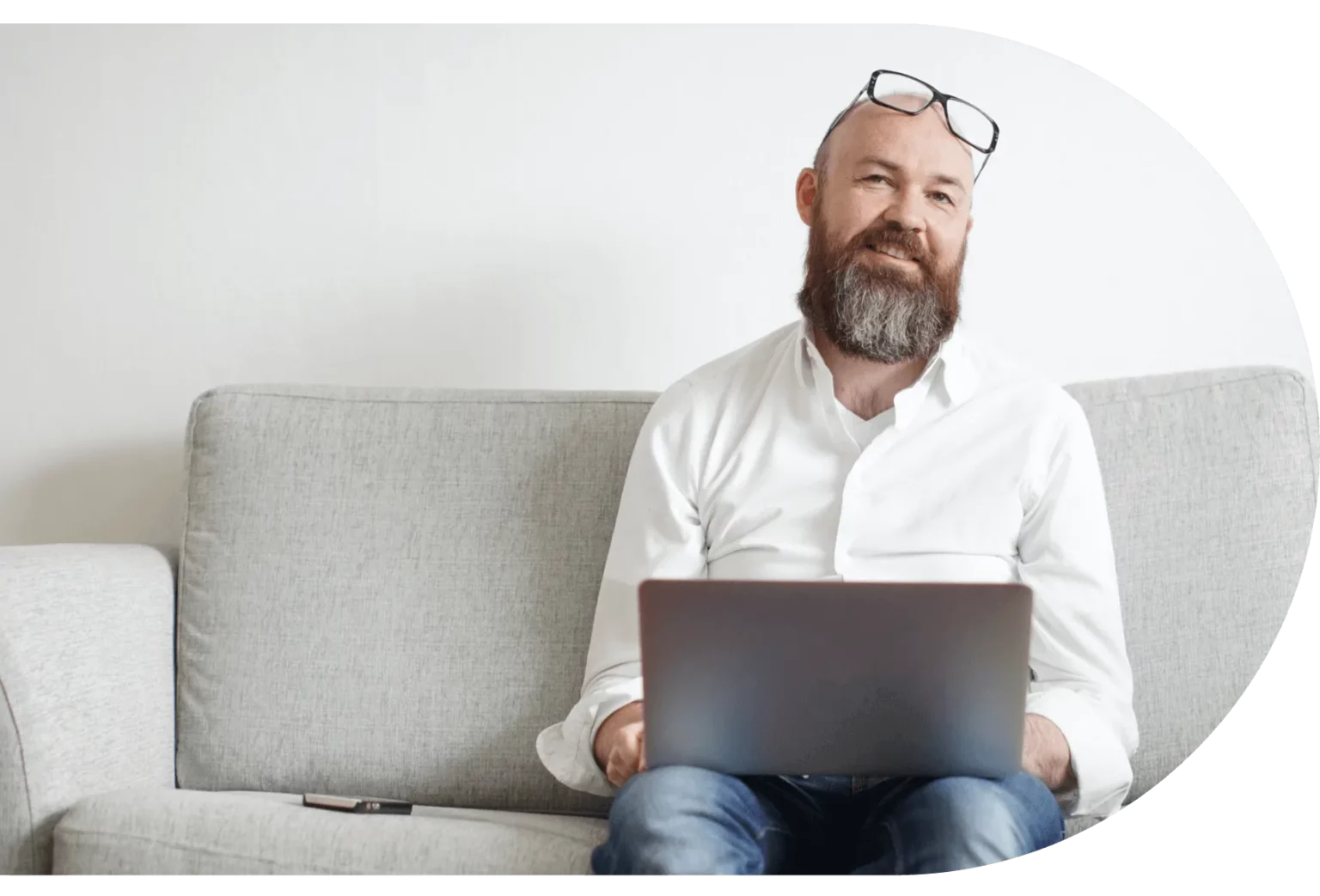 Man sits with a laptop on his lap