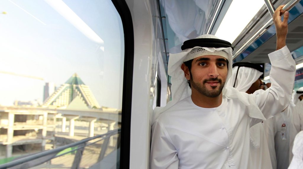 Dubai's Crown Prince Sheikh Hamdan bin Mohammed bin Rashid Al Maktoum rides the metro during the official launch of the Dubai Metro Green Line, September 9, 2011. Spanning 23 kilometres, the Green Line is the second line of the Dubai Metro network, and will run through heavily populated areas such as Deira and Bur Dubai. REUTERS/Jumana El Heloueh (UNITED ARAB EMIRATES - Tags: POLITICS TRANSPORT ROYALS ENTERTAINMENT) - GM1E79A05KN02