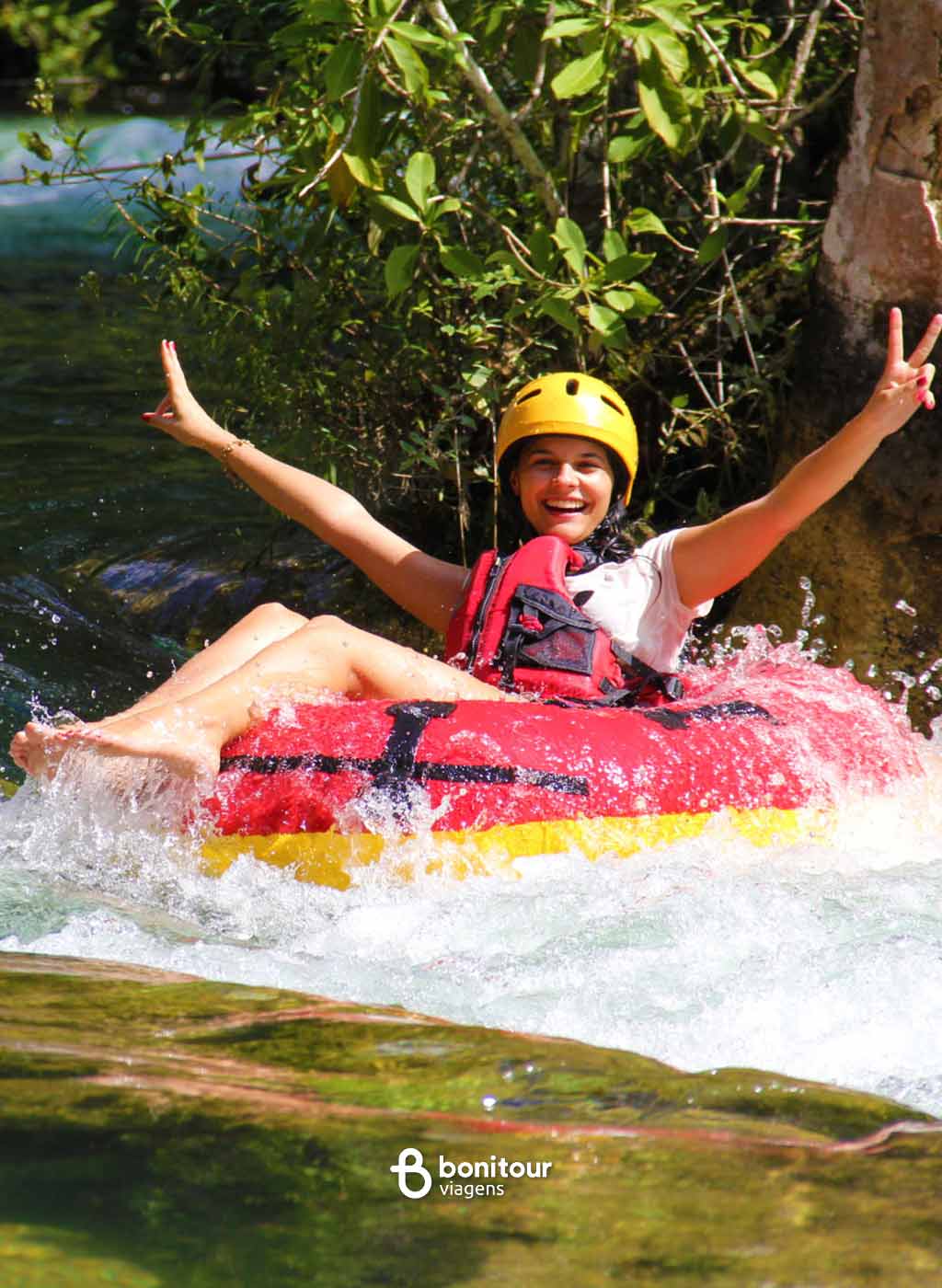 Pessoa de boia descendo pelas águas do rio Formoso em meio a natureza