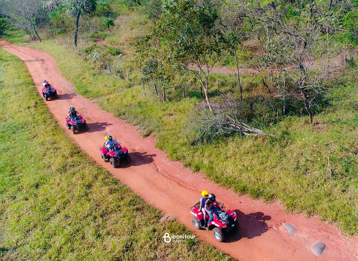 Pessoas dirigindo quadriciclo na estrada da Trilha Boiadeira
