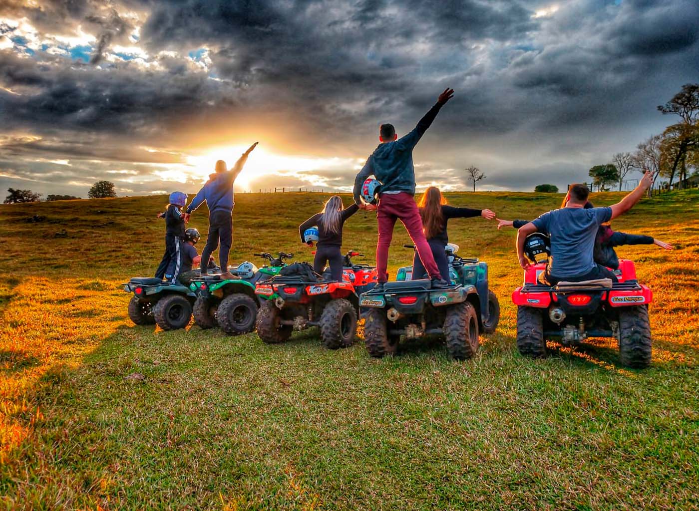 Pessoas curtindo o passeios de quadriciclo ao pôr do sol