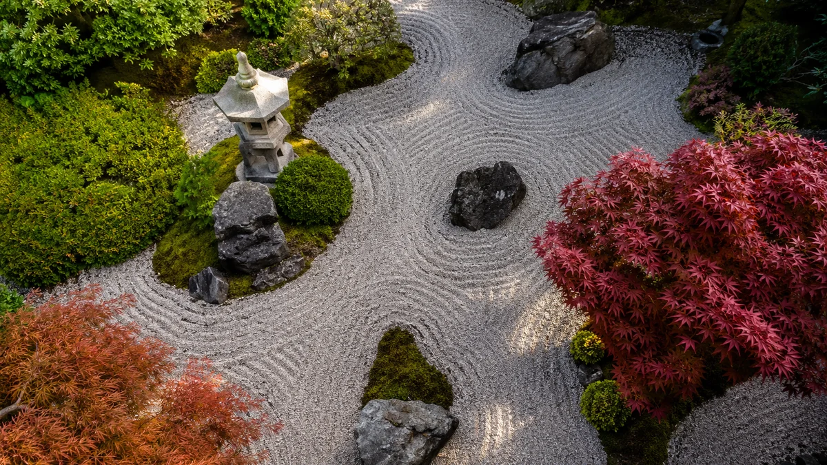 A zen garden with raked gravel and Japanese maples from an overhead view