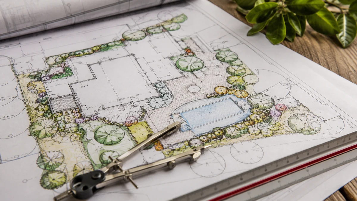 Detailed landscaping blueprint with measurements on a wooden table