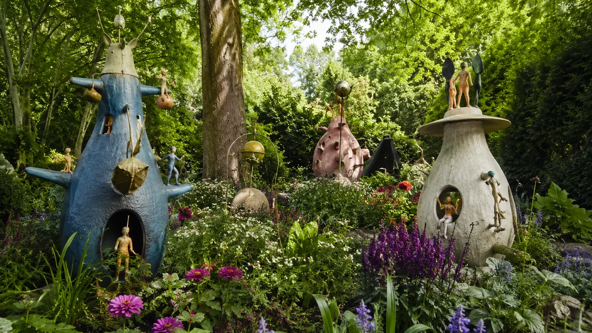 A garden with sculptures and flowering plants in a style inspired by Hieronymus Bosch