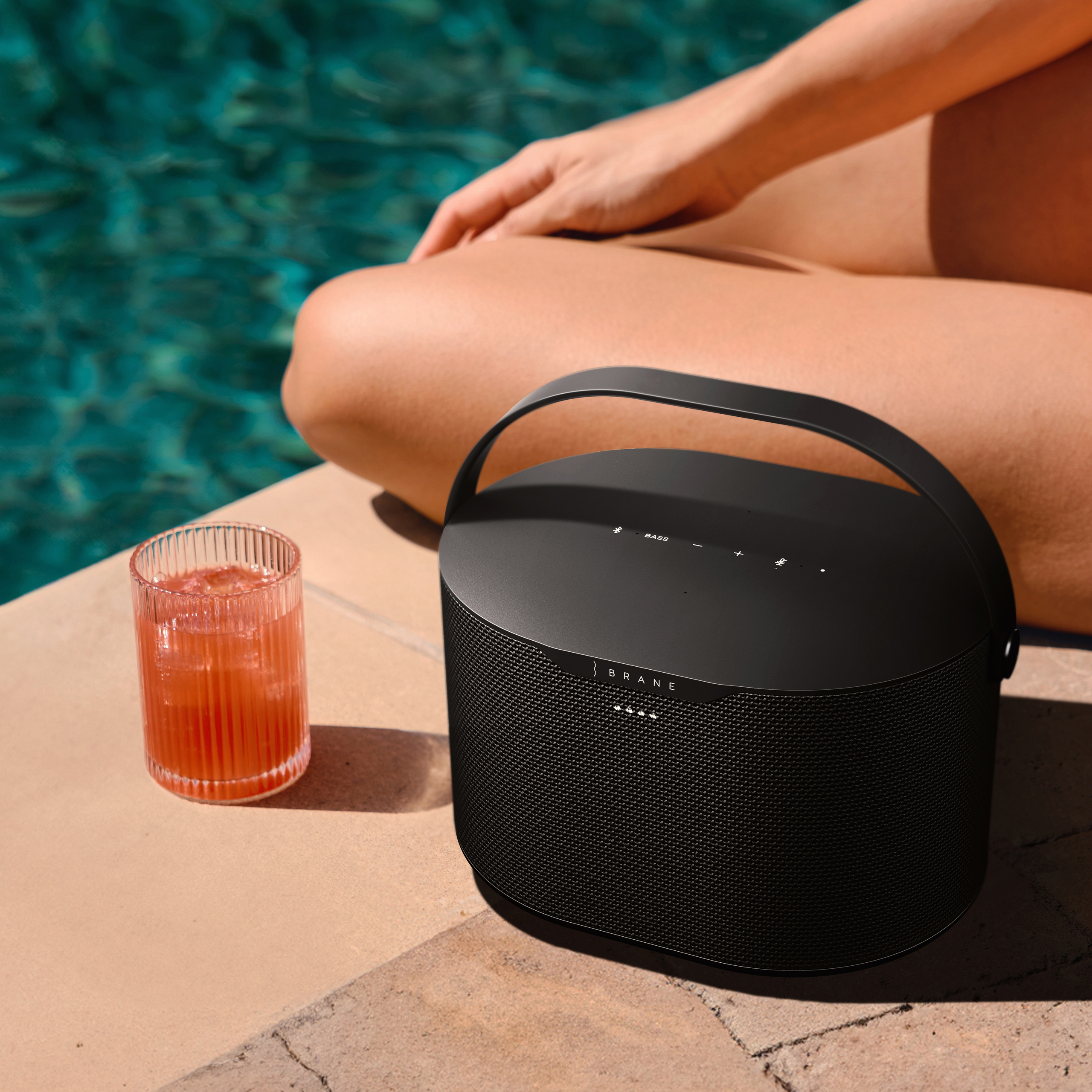 Brane X speaker at the edge of a swimming pool