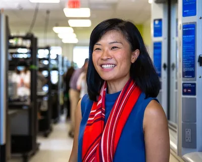 Fengru Lin, co-founder and CEO of TurtleTree, smiling in a lab