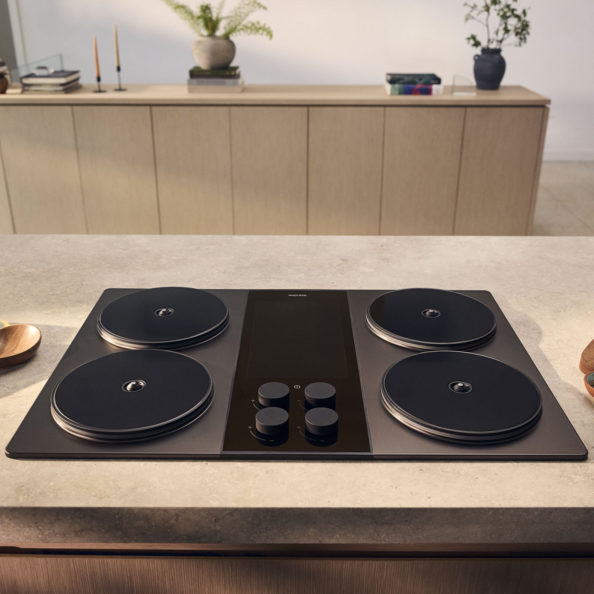 The Impulse Cooktop, a stainless-steel four-burner induction stove with an integrated 3 kWh battery