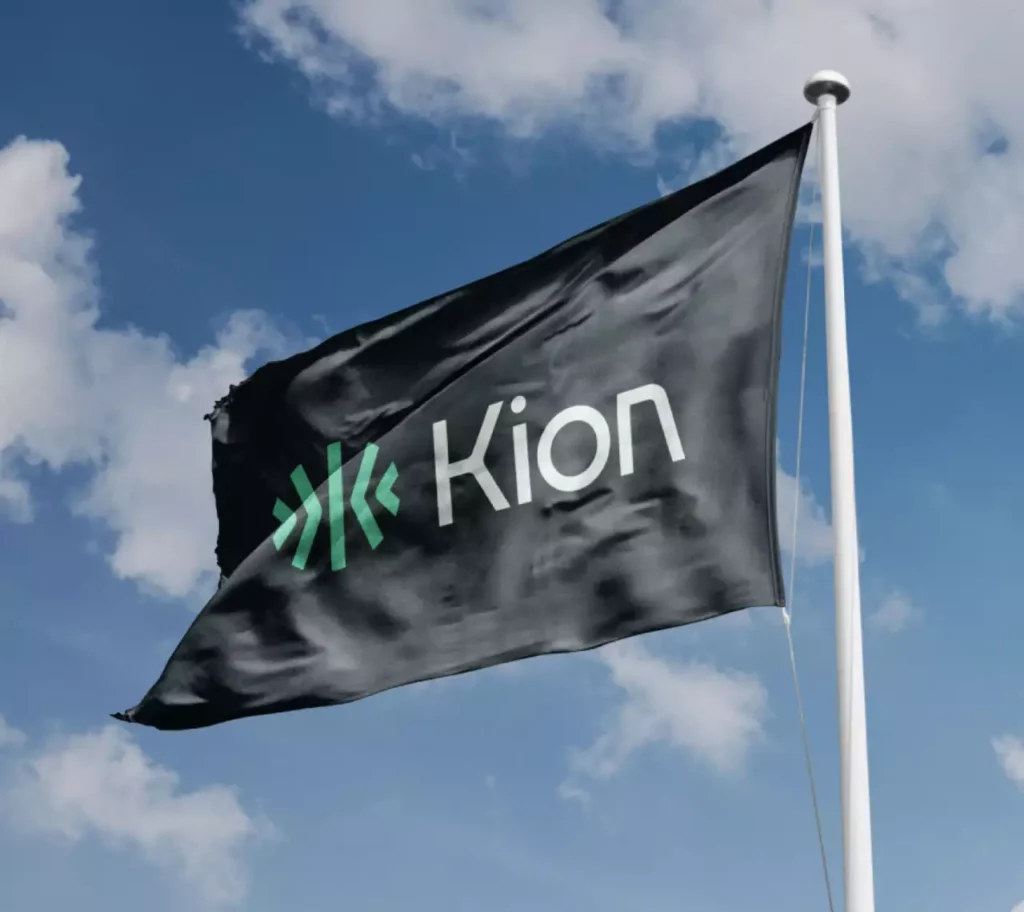 The Kion flag - logomark and wordmark against a blue sky