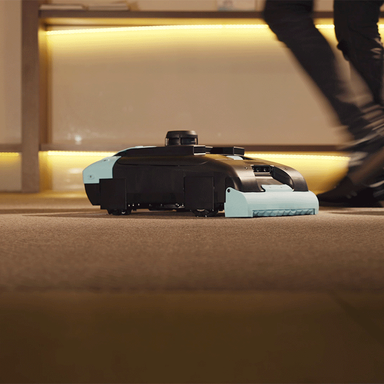 Rosie, the Tailos commercial robot vacuum, in a hotel lobby