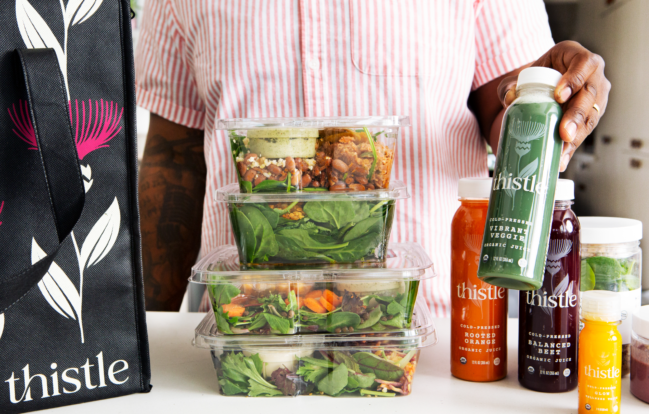 Thistle logo and plant-forward meal imagery