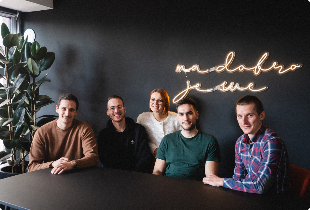 Members of TP Accurate's extended product team gathered around a table