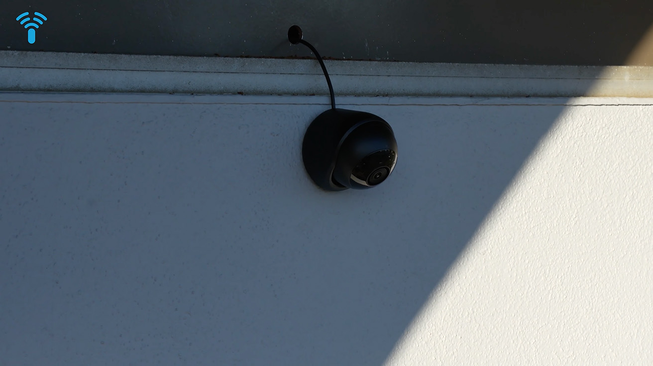 Outdoor installation of the UniFi Protect G6 Turret camera under the building eaves