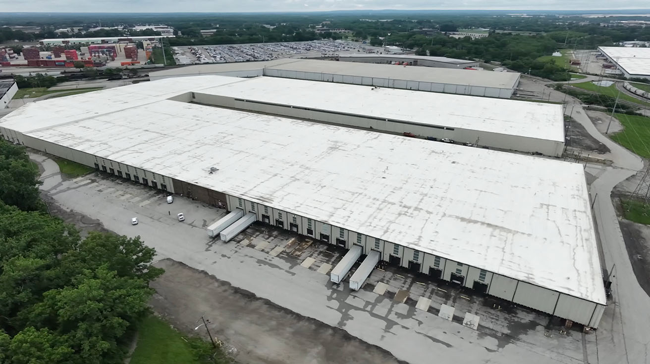 Aerial drone view of a massive 700,000 square foot logistics warehouse facility