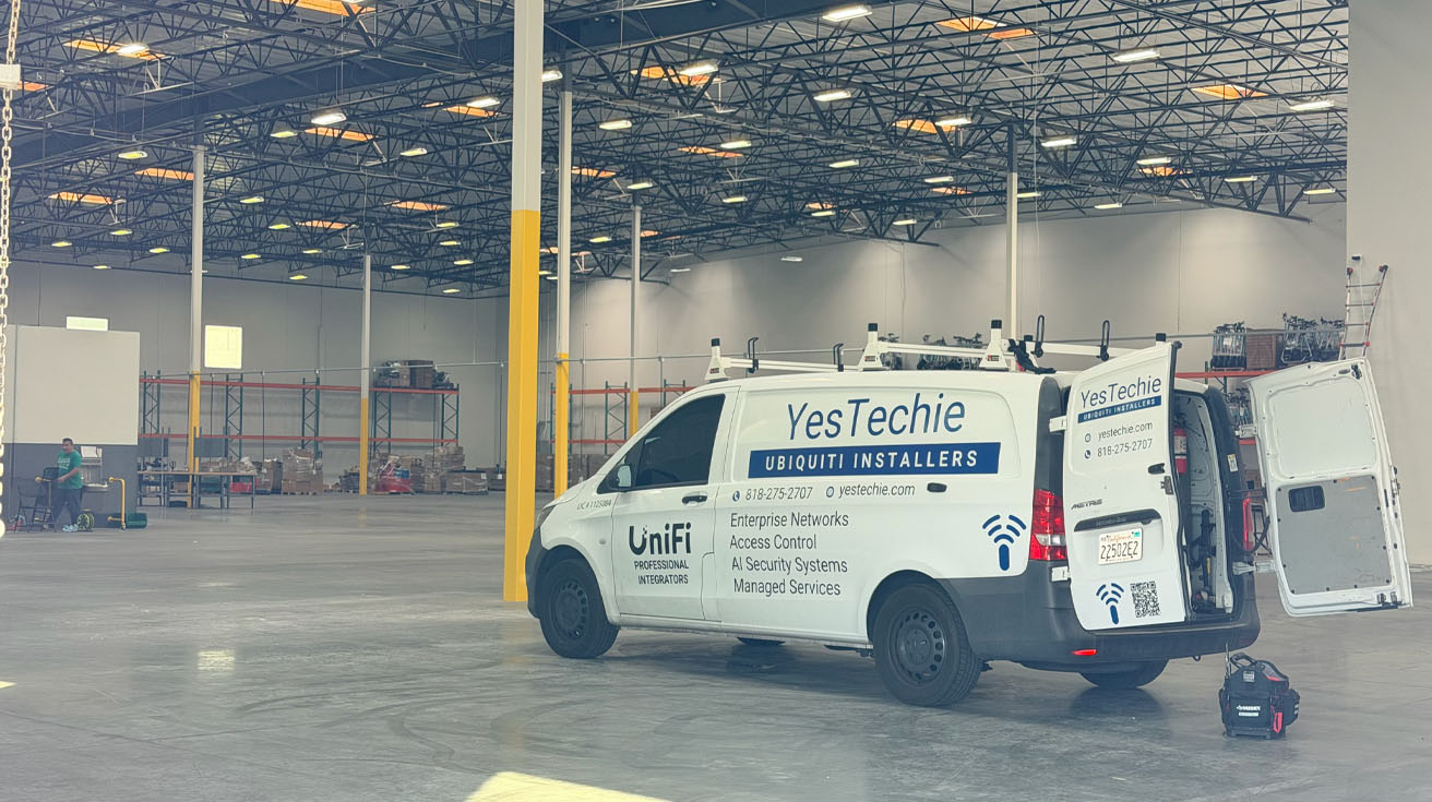 a yestechie branded engineering dispatch van parked inside a large commercial warehouse ready for on-site infrastructure support.