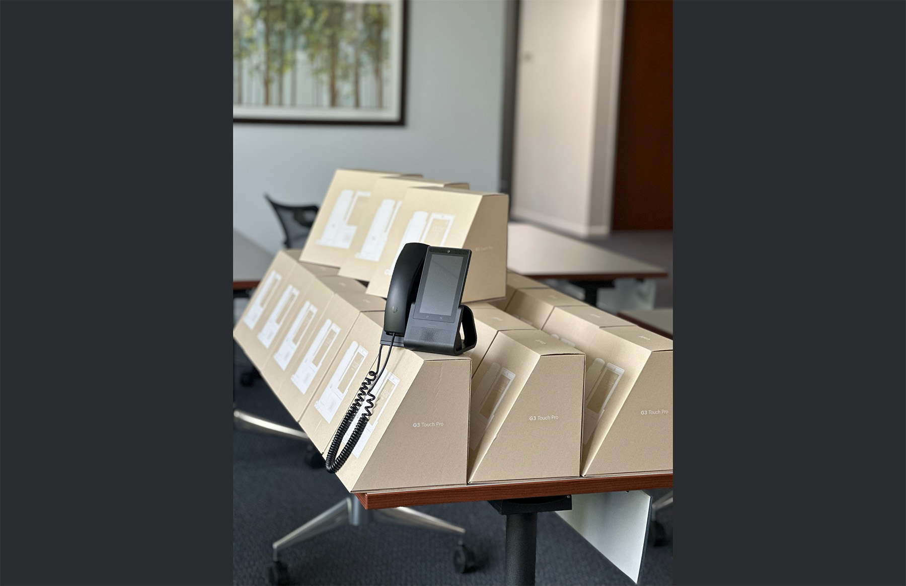 A large scale inventory deployment of UniFi Talk Touch phones ready for corporate telecommunications installation.