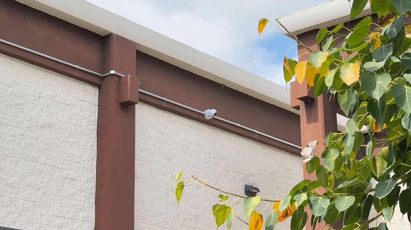 Exterior wall mounted UniFi G6 Turret camera monitoring the parking zone