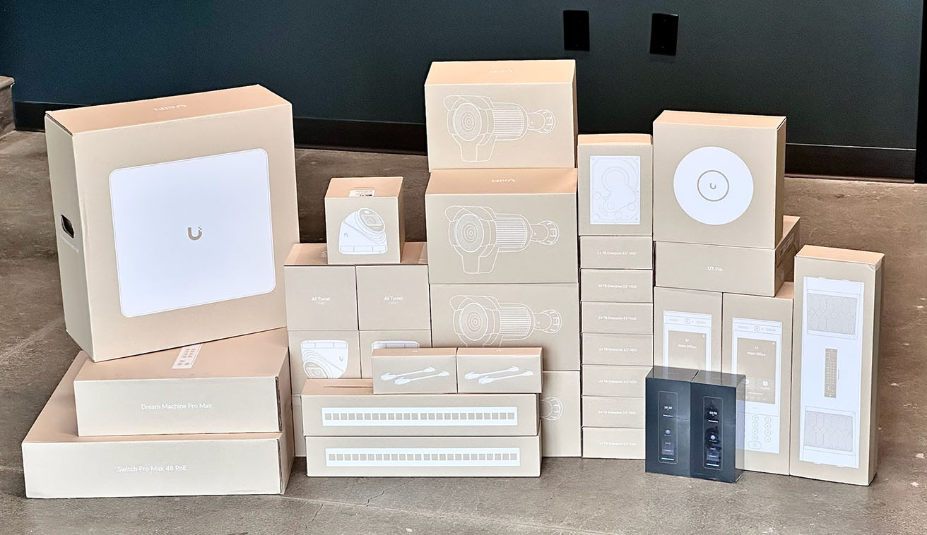 Ubiquiti UniFi equipment, including AI security cameras and access control devices, prepared for high-security warehouse deployment by YesTechie