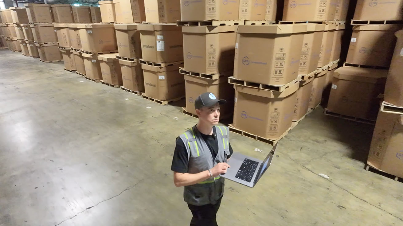 On-site wireless site survey being performed with NetSpot software in a warehouse aisle