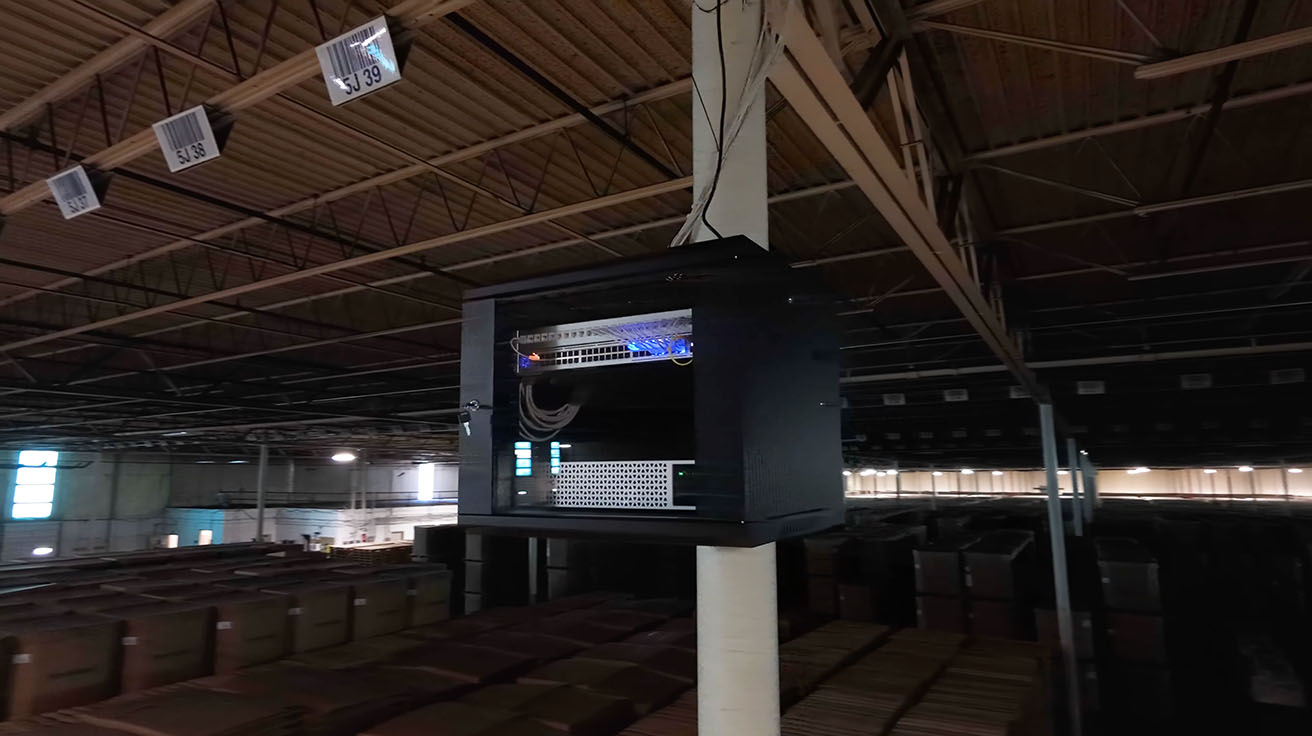 Close-up of a compact UniFi IDF network cabinet mounted on a structural pillar