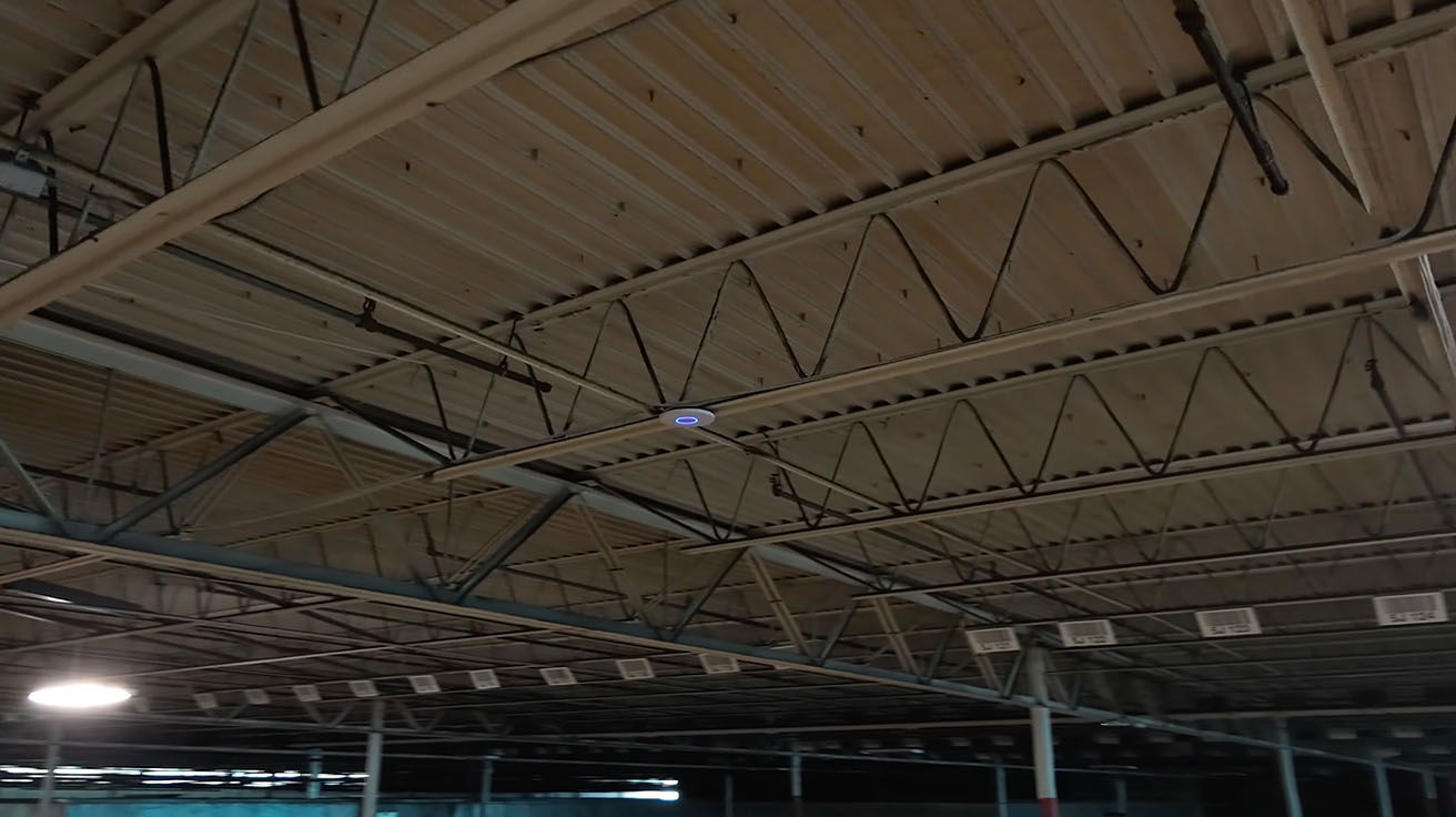 Close-up of a ceiling-mounted UniFi U7 Pro access point in an industrial environment