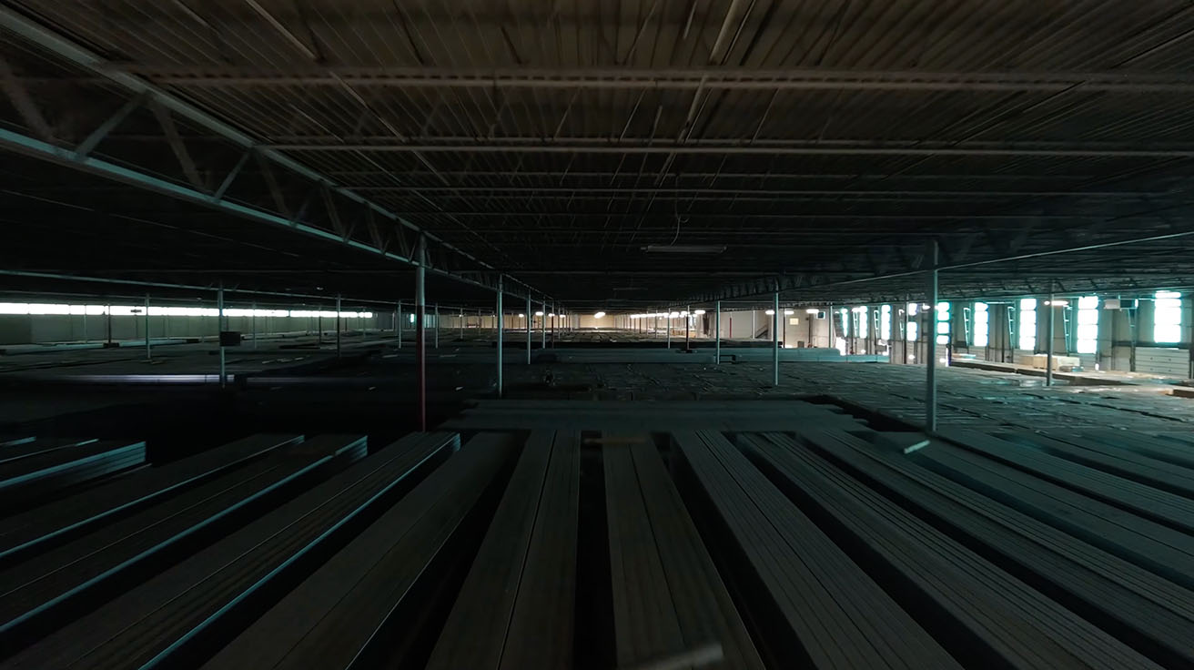 Symmetrical view down a warehouse aisle with deployed Wi-Fi 7 infrastructure