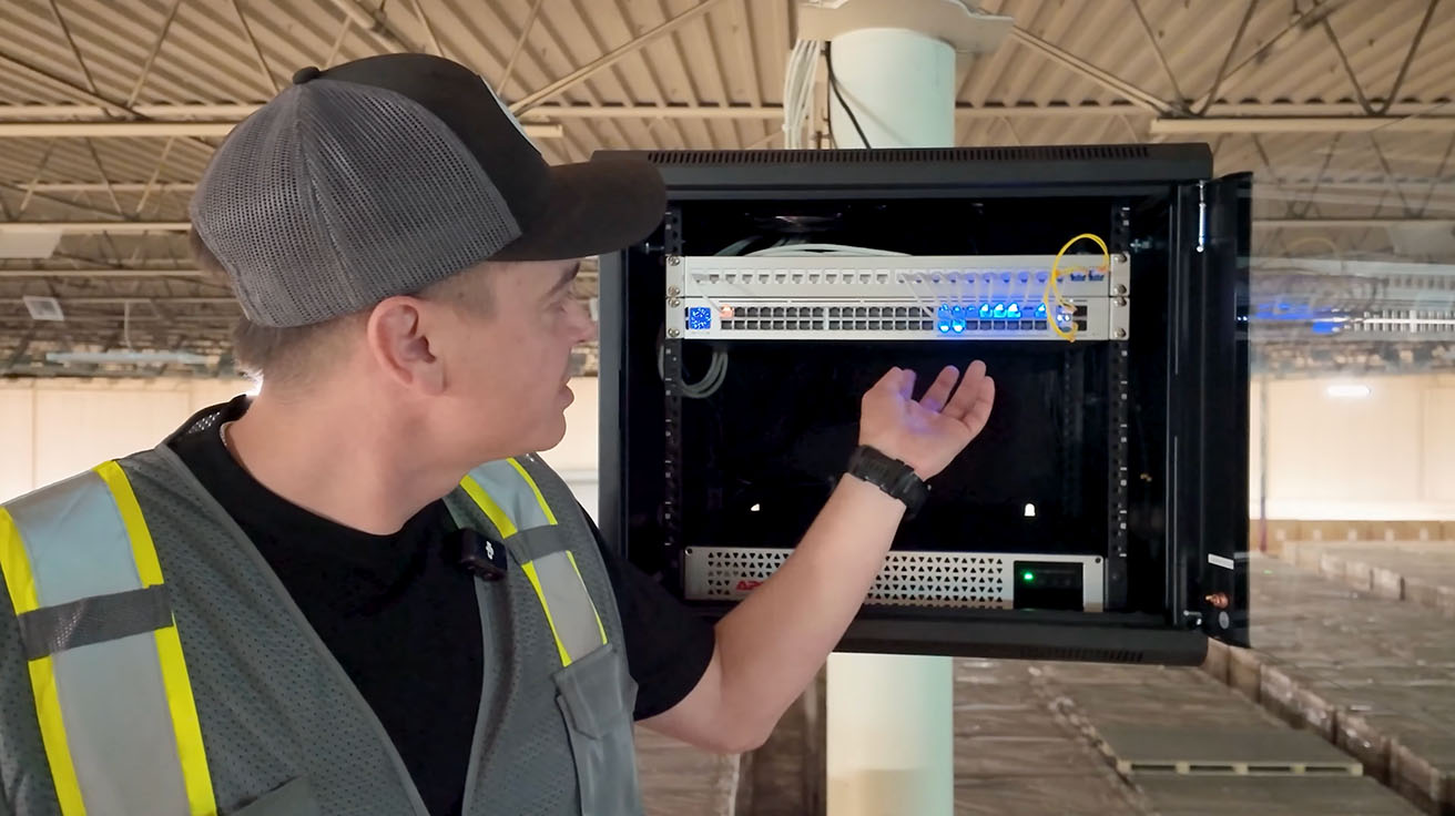 YesTechie network engineer servicing a UniFi switch inside an open IDF enclosure