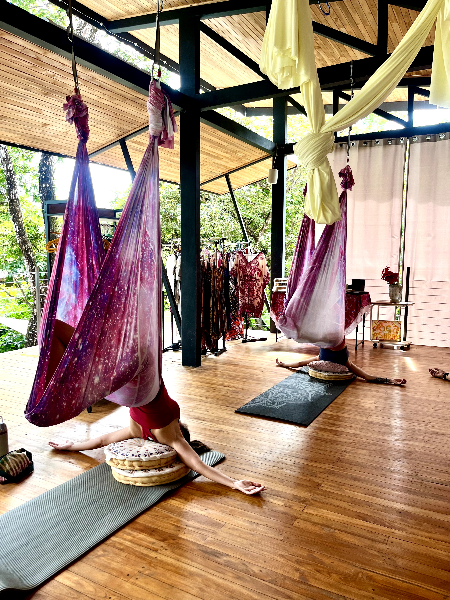 Person resting in a low-hanging aerial silk