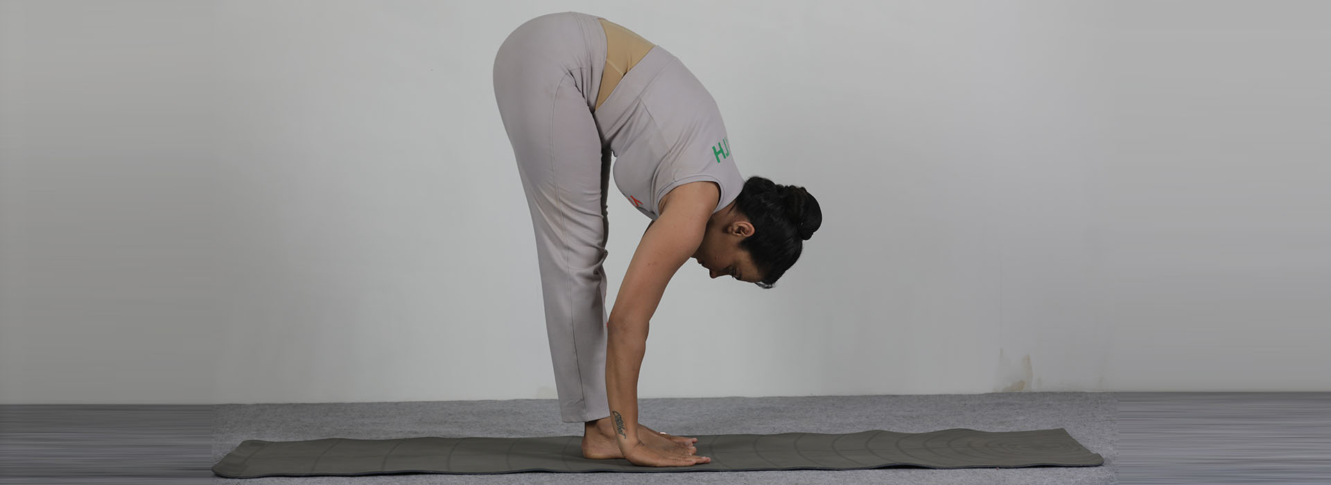 Yoga: Forward fold hands under feet stretch