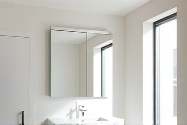 Modern bathroom with organized sliding mirror cabinet.