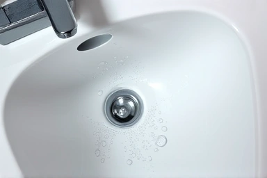 Sparkling clean bathroom sink with reflection