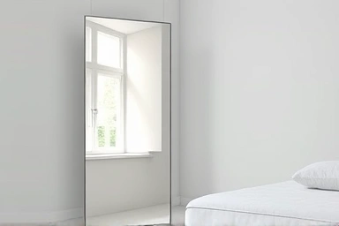 Elegant bedroom design with a frameless full-length mirror.