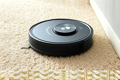 Robot vacuum cleaning thick carpet, lifting dirt and pet hair.