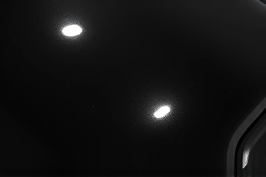 Glossy black car paint with subtle swirl marks under dramatic lighting.