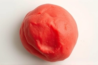 Close-up texture comparison of soft playdough and firm i-clay.
