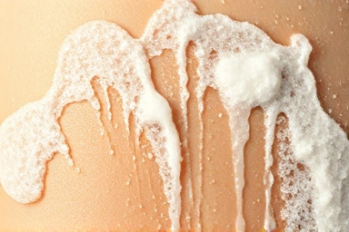 Gentle body wash effectively removing sunscreen residue from clean skin.