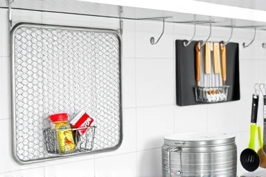 Organized kitchen counter with a net mesh organizer.